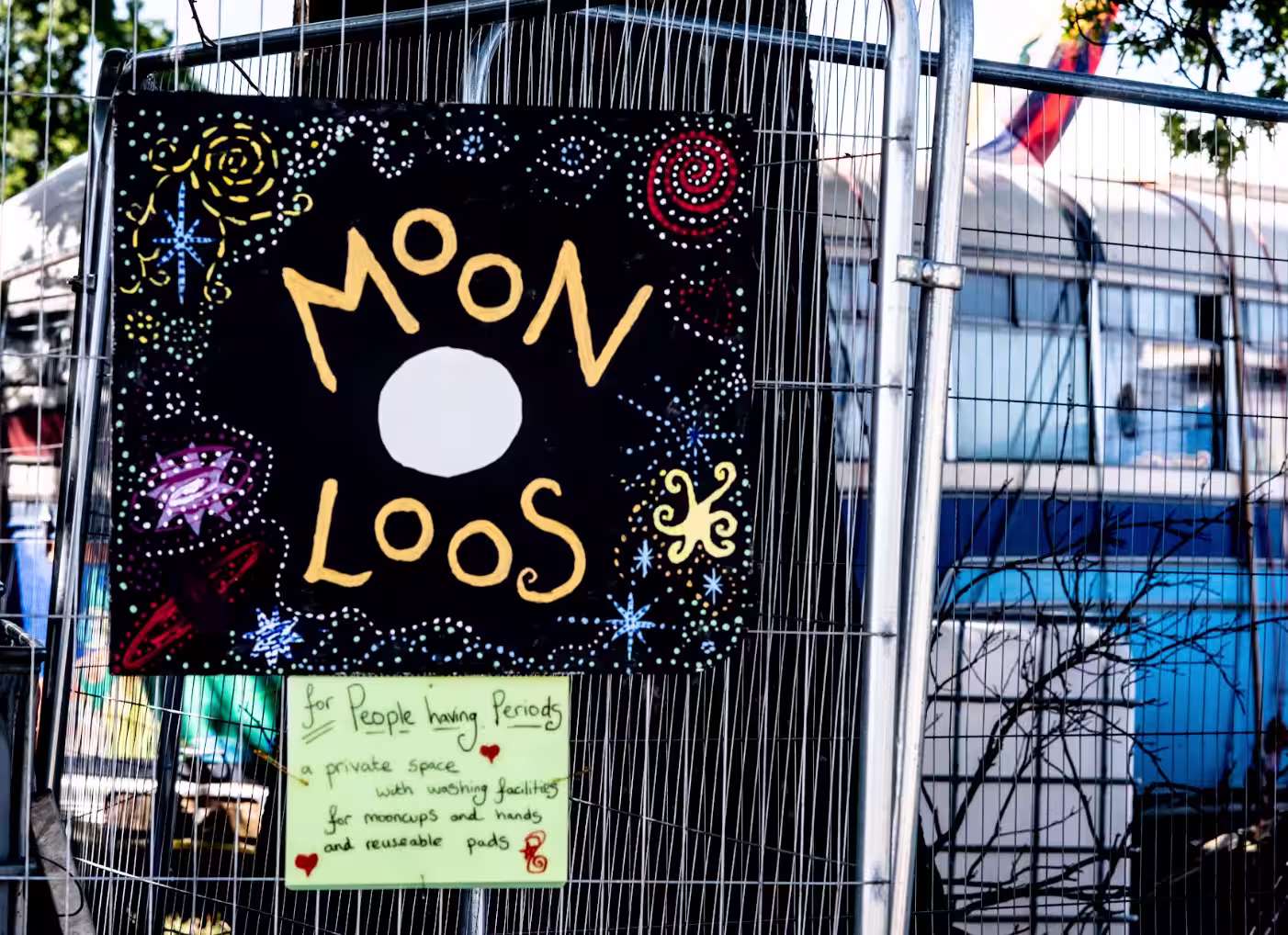 Sign for the Moon Loos for people having periods. The sign says "a private space with washing facilities for mooncups and hands and reusable pads"