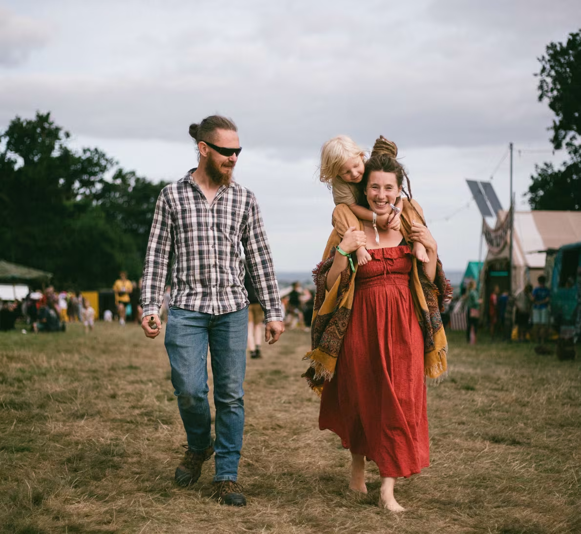 Green Gathering - couple and child walking