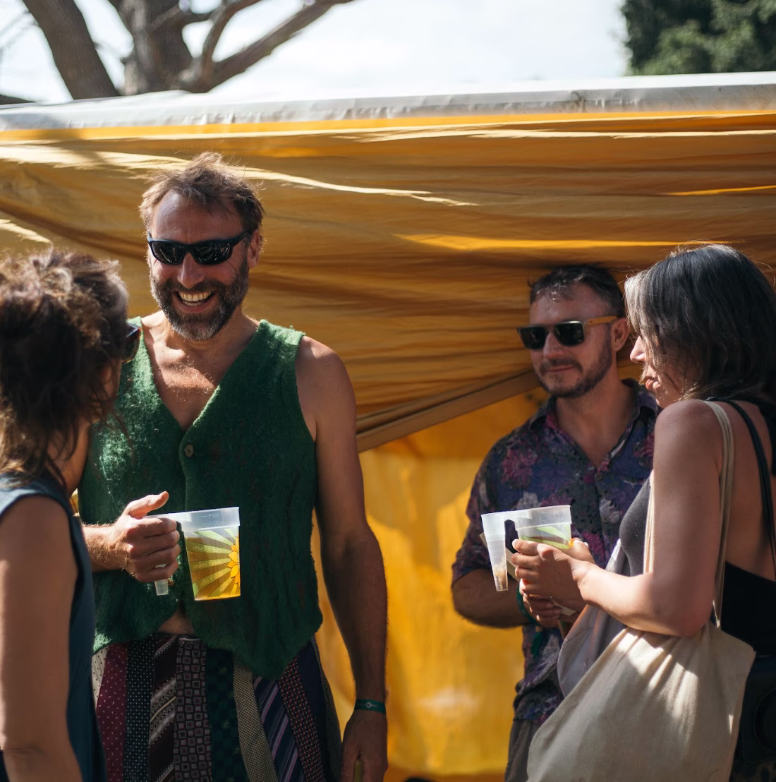 Green Gathering - festival goers chatting with drinks